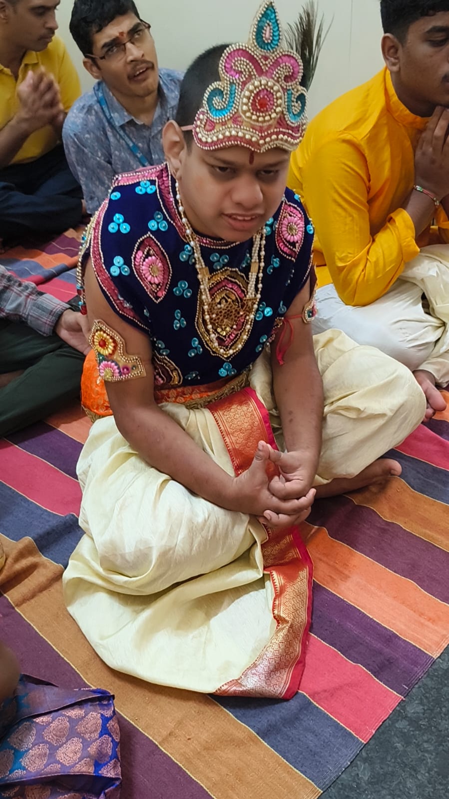 A student dressed as Lord Krishna for the Janmashtami celebration